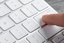 Woman Pressing Button On Computer Keyboard, Closeup