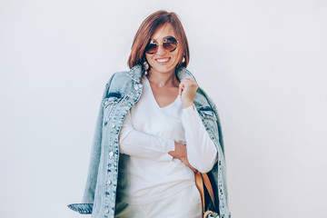 Happy elegant smiling woman in denim jacket