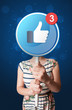 © ra2 studio - Casual young woman holding round sign with facebook like