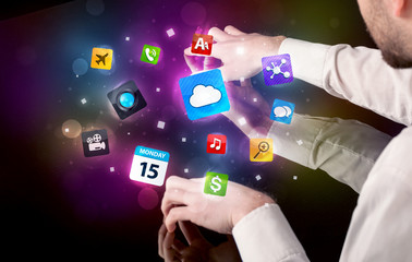 Poster - Male hands touching interactive table with colorful application icons on it 
