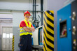 © Marko Rupena - Smiling factory technician beside a machine