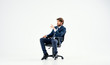 © SHOTPRIME STUDIO - man sitting on a black chair on an isolated background