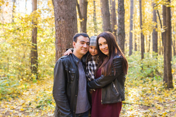 Wall Mural - Children, nature and family concept - Portrait of happy family over autumn park background