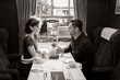 © Tony Marturano - Vintage couple holding hands over table of train carriage