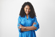 © shurkin_son - Waist up isolated shot of joyful attractive young African American woman with Afro hairstyle expressing good positive emotions, looking at camera with broad smile, keeping arms folded on her chest