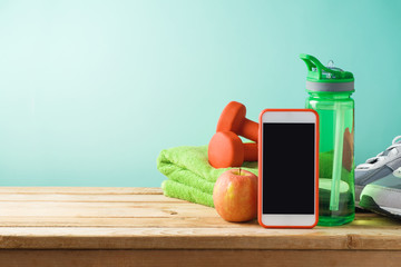 Wall Mural - Fitness background with bottle of water, dumbbells and smart mobole phone