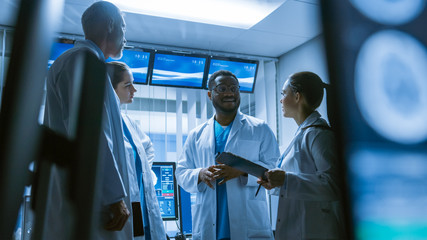 Low Angle Shot of the Meeting of the Team of Medical Scientists in the Brain Research Laboratory. Neurologists / Neuroscientists Having Analytical Discussion