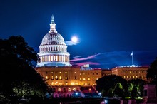 United Stated Capital Dome Illuminated At Night With Full Moon In Background