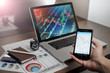 © MuhammadSyafiq - A Computer Tablet and ultra-slim smartphone with candle stick chart on the screen a business and finance conceptual