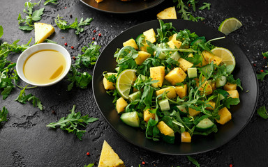 Wall Mural - Pineapple Cucumber salad with wild green rocket, lime and olive oil. Healthy juicy food