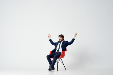 Wall Mural - business man sitting on a red chair in the office