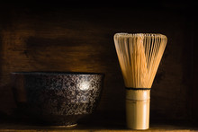 Japanese Matcha Green Tea Whisk Or Chasen With A Chawan Or Traditional Ceramic Bowl Shot With Dark Creative Lighting