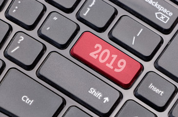 Aufkleber - 2019 on red enter key, of a black keyboard.