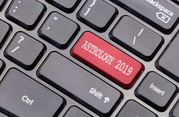 Aufkleber - Astrology 2019 red on enter key, of a black keyboard.