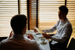 © Comeback Images - Communicating businessmen in cafe
