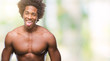 Afro american shirtless man showing nude body over isolated background sticking tongue out happy with funny expression. Emotion concept.