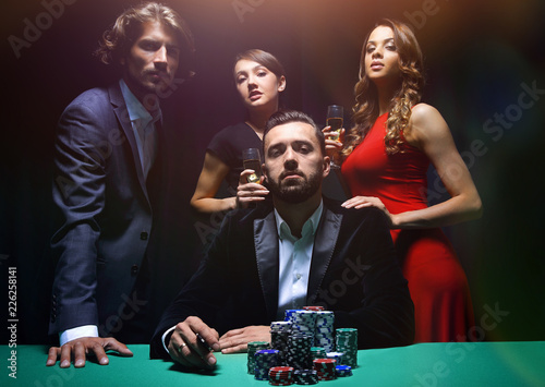 фотография Attractive young caucasian man make bet in the casino
