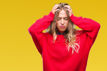 Poster - Beautiful young blonde woman wearing winter sweater over isolated background suffering from headache desperate and stressed because pain and migraine. Hands on head.