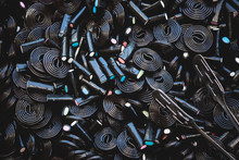 Black Or Brown Candy Spiral Background. Licorice Wheels Candies. Dark Jelly Flavored Licorice. Top View.