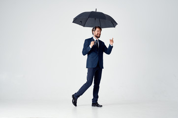 man with an open umbrella on bright background