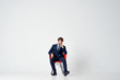 © SHOTPRIME STUDIO - man in a suit sitting on a red chair