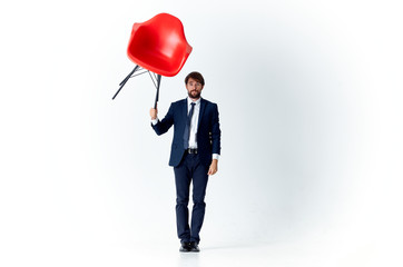 Poster - man holding a red chair over his head