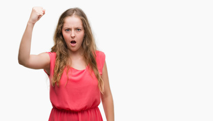 Wall Mural - Young blonde woman wearing pink dress annoyed and frustrated shouting with anger, crazy and yelling with raised hand, anger concept