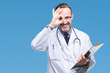 Middle age senior hoary doctor man holding clipboard over isolated background with happy face smiling doing ok sign with hand on eye looking through fingers