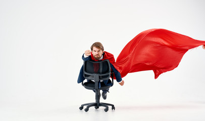 man riding on a chair with a red sheet