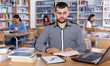 © JackF - man engaged in research, working with laptop and books