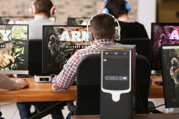 Wall Mural - Young people playing video games at tournament