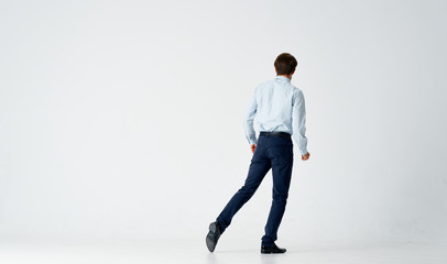 a man in a shirt is standing back