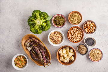 Wall Mural - Vegan protein source. Tofu, beans, chickpeas, nuts and seeds on a white background, top view, copy space.