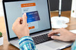 © Atstock Productions - Hand of a man holding credit card making payment online with laptop computer