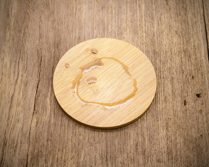 Poster - Coffee stain on beverage coaster mug made from wooden material in retro background.