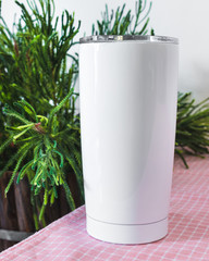 White steel bottle on kitchen table background. Blank drink mug for design.