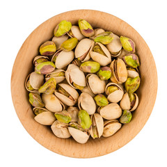 Pistachios in wooden bowl isolated on white background.