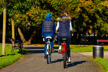 Healthy lifestyle - people riding bicycles in city park