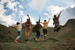 © Yakobchuk Olena - Lets jump. Excited young hikers having fun and jumping while being in the mountains