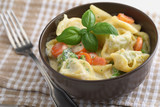 Fototapeta Do przedpokoju - Tortellini with vegetables under cream sauce