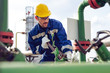 © zorandim75 - Worker adjusting gauge at oil refinery