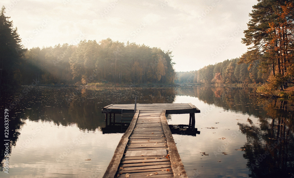 The Breath Of Autumn. Autumn foliage and fog lake in morning with boat dock - obrazy, fototapety, plakaty 