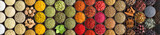 Various spices and herbs as a background. Colorful condiments in cups, top view