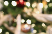 Abstract Background Of An Out Of Focus Christmas Tree With Blurred Bokeh Lights Background.
