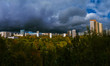 Panorama residential disctrict of Moscow at autumn with dark beautiful rainy clouds in the blue sky, soviet buildings, a large park – panoramic view of the city in high resolution