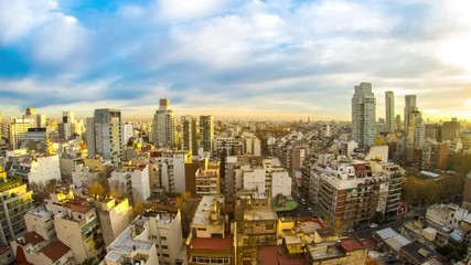 Wall Mural - Time-lapse view on the skyline of the city as colorful clouds pass by in the light of the setting sun in Buenos Aires, Argentina.
