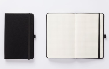 open and closed notebook on white background