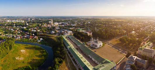 Wall Mural - Beautiful panoramic view of Suzdal in summer at sunrise. Resurrection Church on the market square in Suzdal. Suzdal is a famous tourist attraction and part of the Golden Ring of Russia