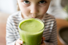 Young Girl Drinking Green Smoothie