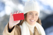 © Antonioguillem - Woman showing a blank credit card in winter